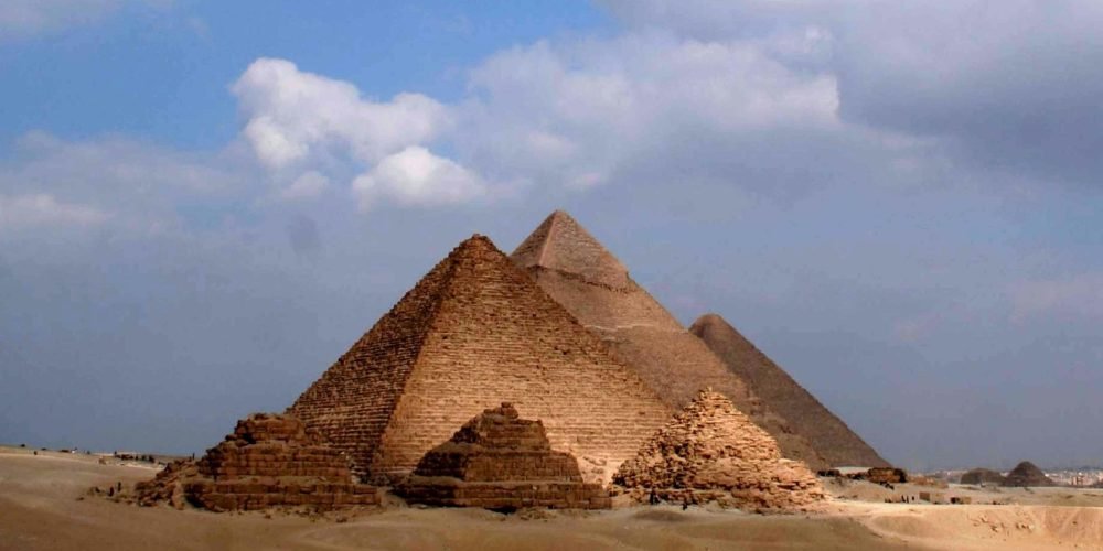 Giza Pyramids standing under a clear blue sky.