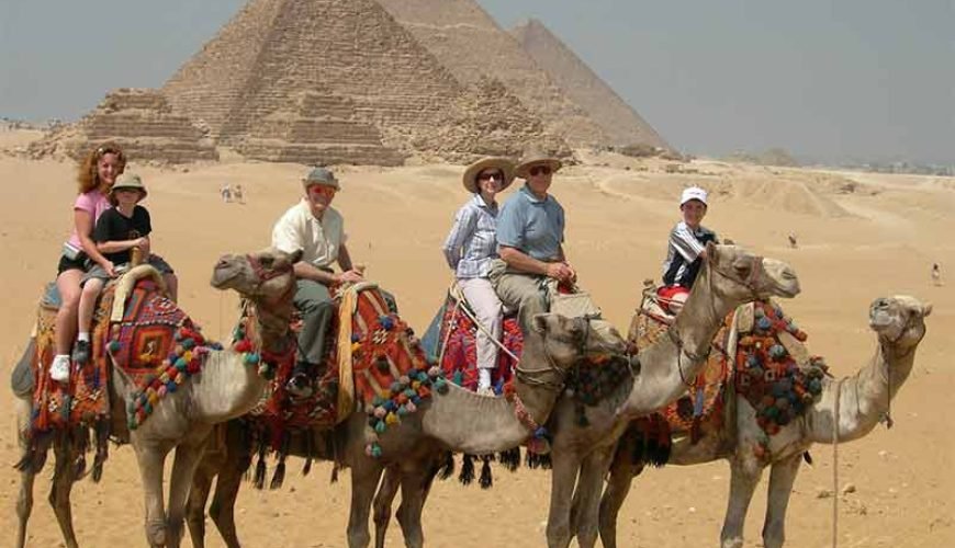 Family enjoying a camel ride in the area of Pyramids of Giza