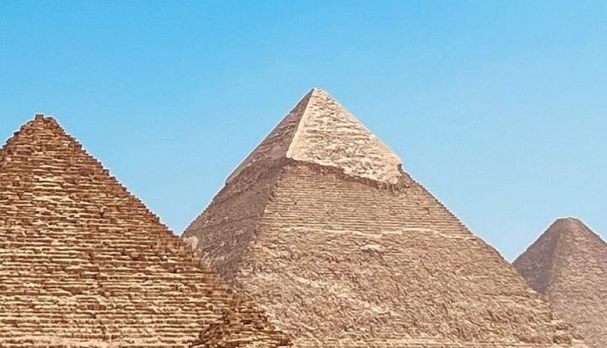 Three Pyramids of Giza under a clear blue sky
