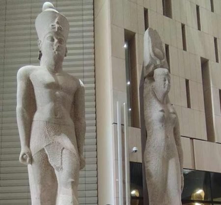 Two royal statues displayed on the grand staircase inside the Egyptian Museum.