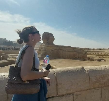 Jeune femme admirant le Grand Sphinx de Gizeh dans le cadre du Forfait au Caire Louxor Assouan et Désert blanc