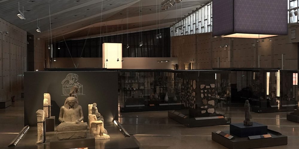Interior view of the Grand Egyptian Museum showcasing ancient statues and artifacts on display