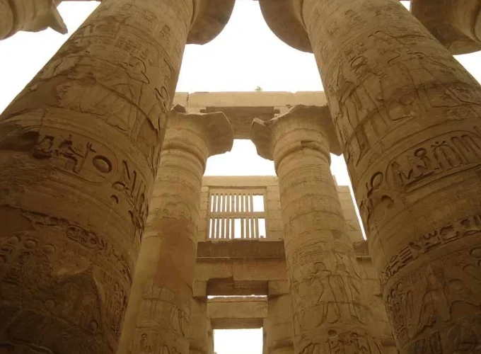 Grandes columnas del Templo de Karnak en Egipto, decoradas con jeroglíficos y relieves.