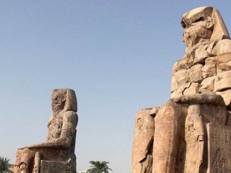 The Colossi of Memnon, two massive seated statues of Pharaoh Amenhotep III in Luxor.