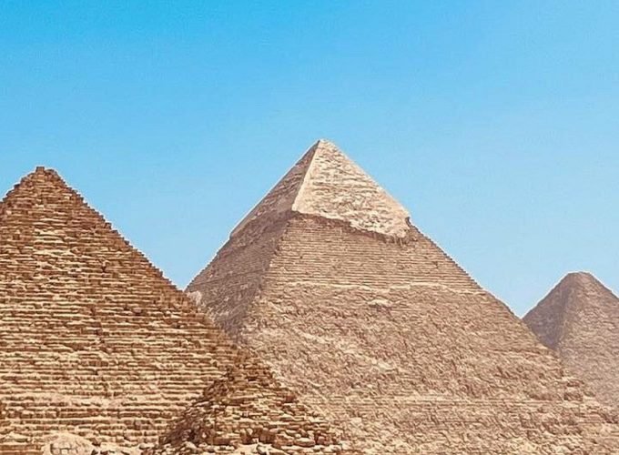 Three Pyramids of Giza under a clear blue sky