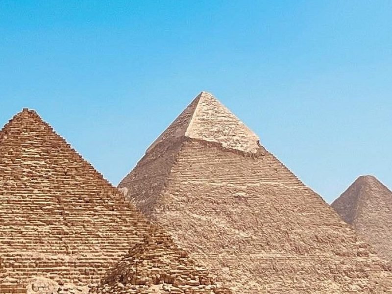 Three Pyramids of Giza under a clear blue sky