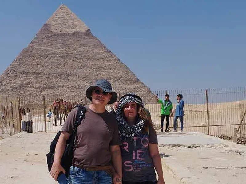A couple visiting the Pyramids of Giza, enjoying the view of the ancient wonders