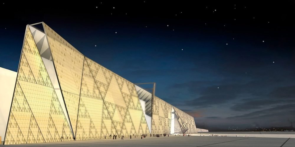 Grand Egyptian Museum exterior illuminated by stars and moonlight at night.
