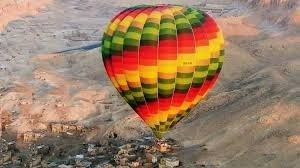 Hot air balloon flying over Queen Hatshepsut Temple in Luxor