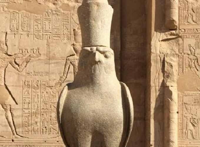 Statue of the god Horus guarding the entrance of Edfu Temple