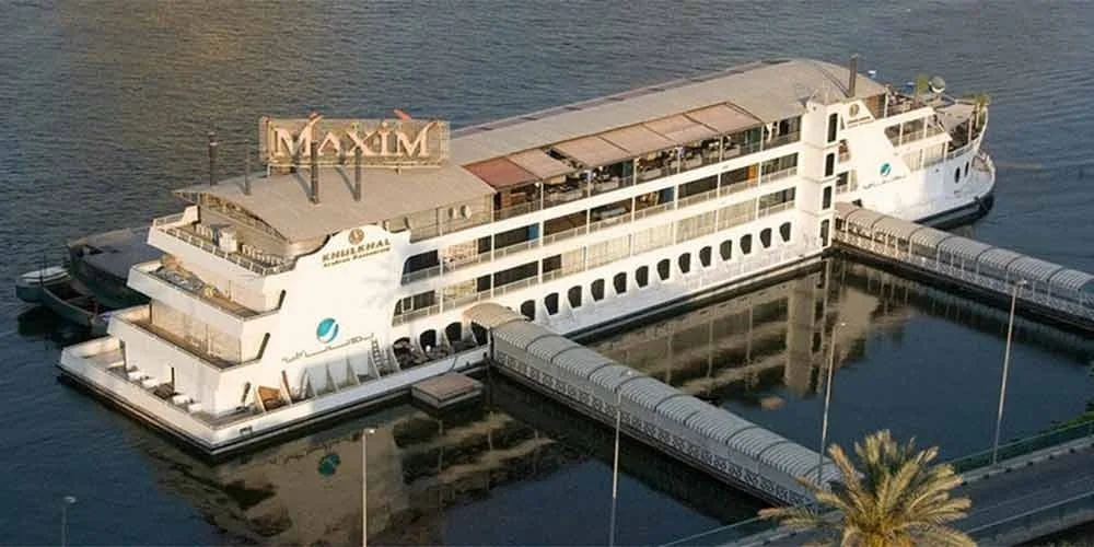 A view of a dinner cruise boat illuminated on the Nile River