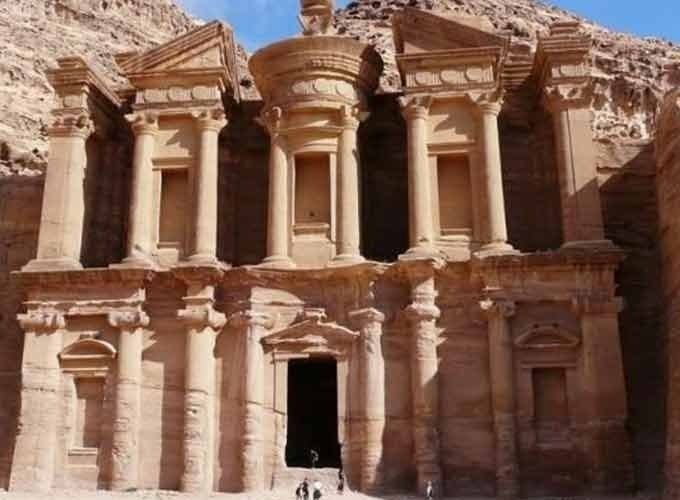 Petra in Jordan is an ancient city carved into red sandstone cliffs, famous for its Rose City architecture