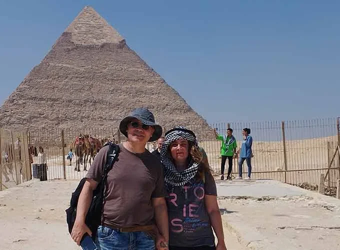 A couple visiting the Pyramids of Giza, enjoying the view of the ancient wonders