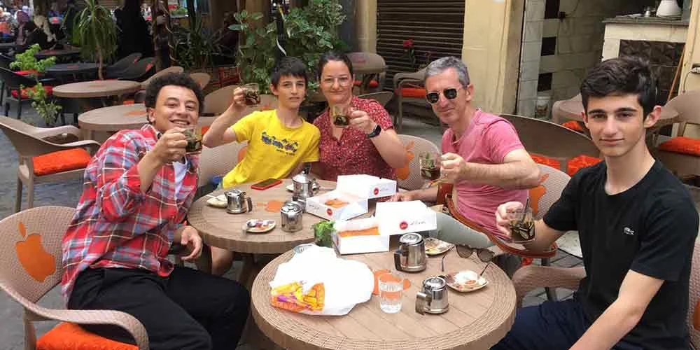 A family sharing the joy of a traditional Egyptian dessrts