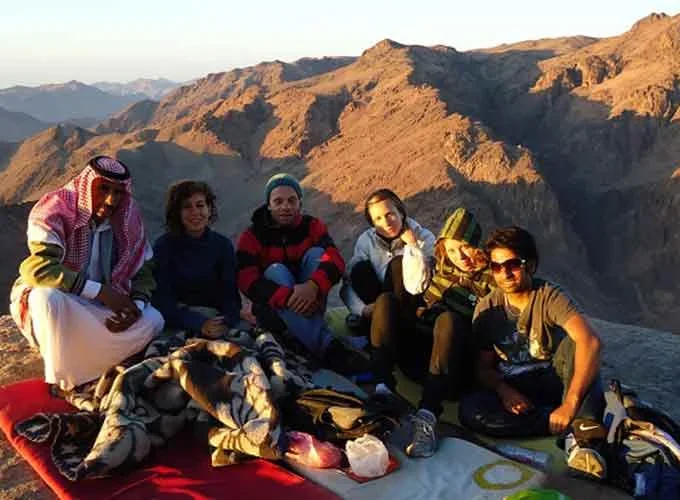 A group of tourists at the top of Mount Saint Catherine