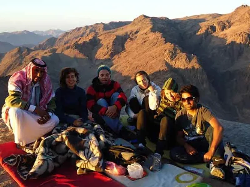 A group of tourists at the top of Mount Saint Catherine