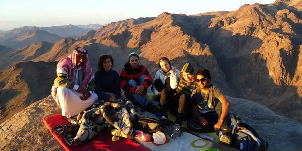 A group of tourists at the top of Mount Saint Catherine