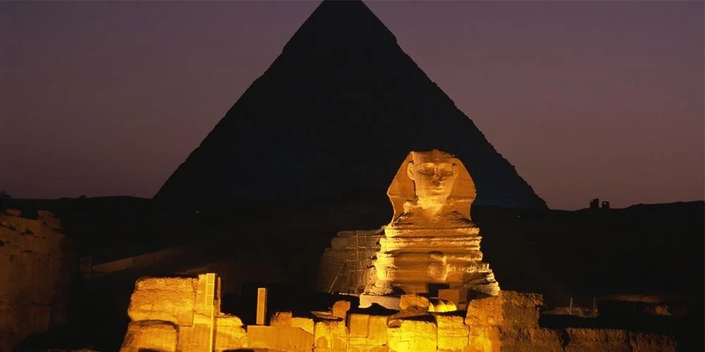 The Sphinx illuminated during the Sound and Light Show at night in Giza