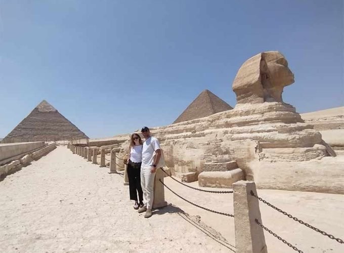 2 Tourists at Giza pyramids area and near to Sphinx