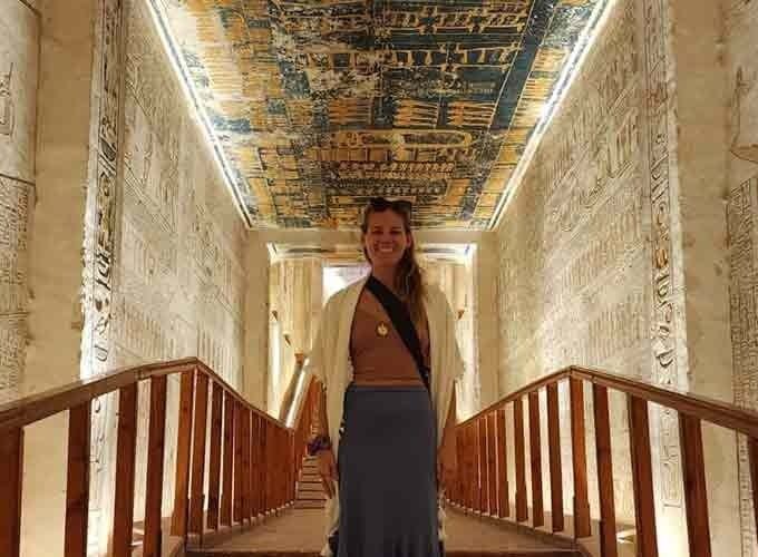 A tourist taking a photo inside the Valley of the Kings in Luxor