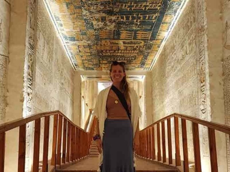 A tourist taking a photo inside the Valley of the Kings in Luxor