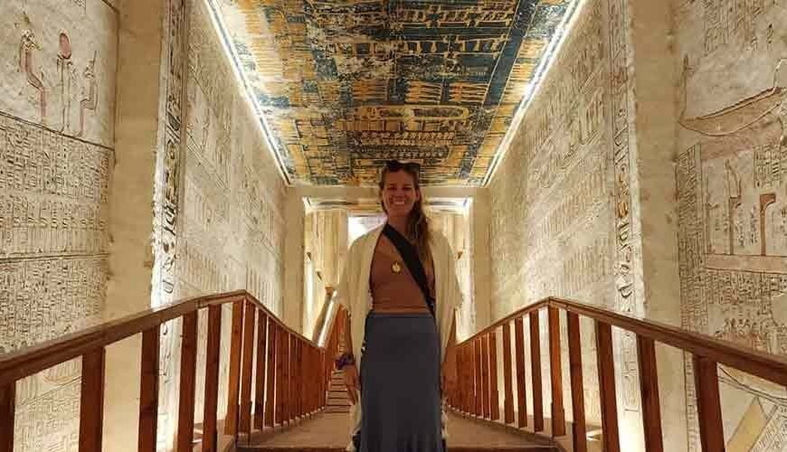 A tourist taking a photo inside the Valley of the Kings in Luxor